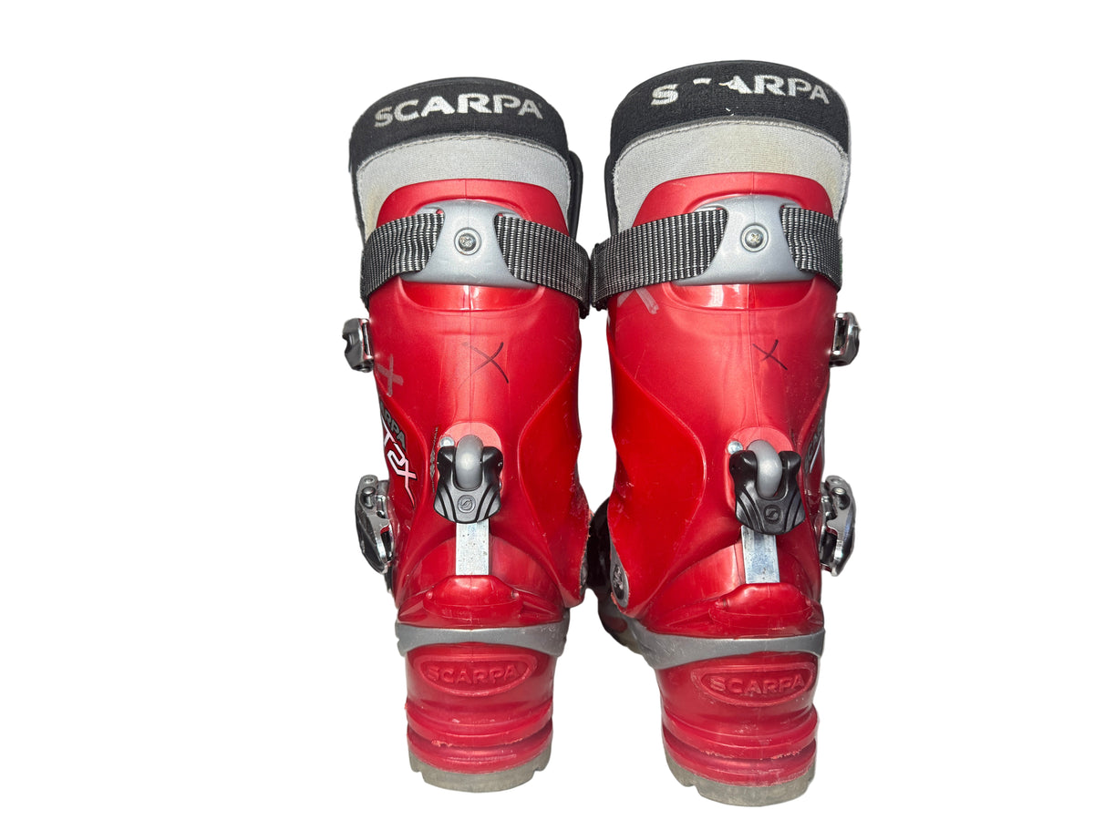 Red ski boots with 'Scarpa' branding on a white surface.