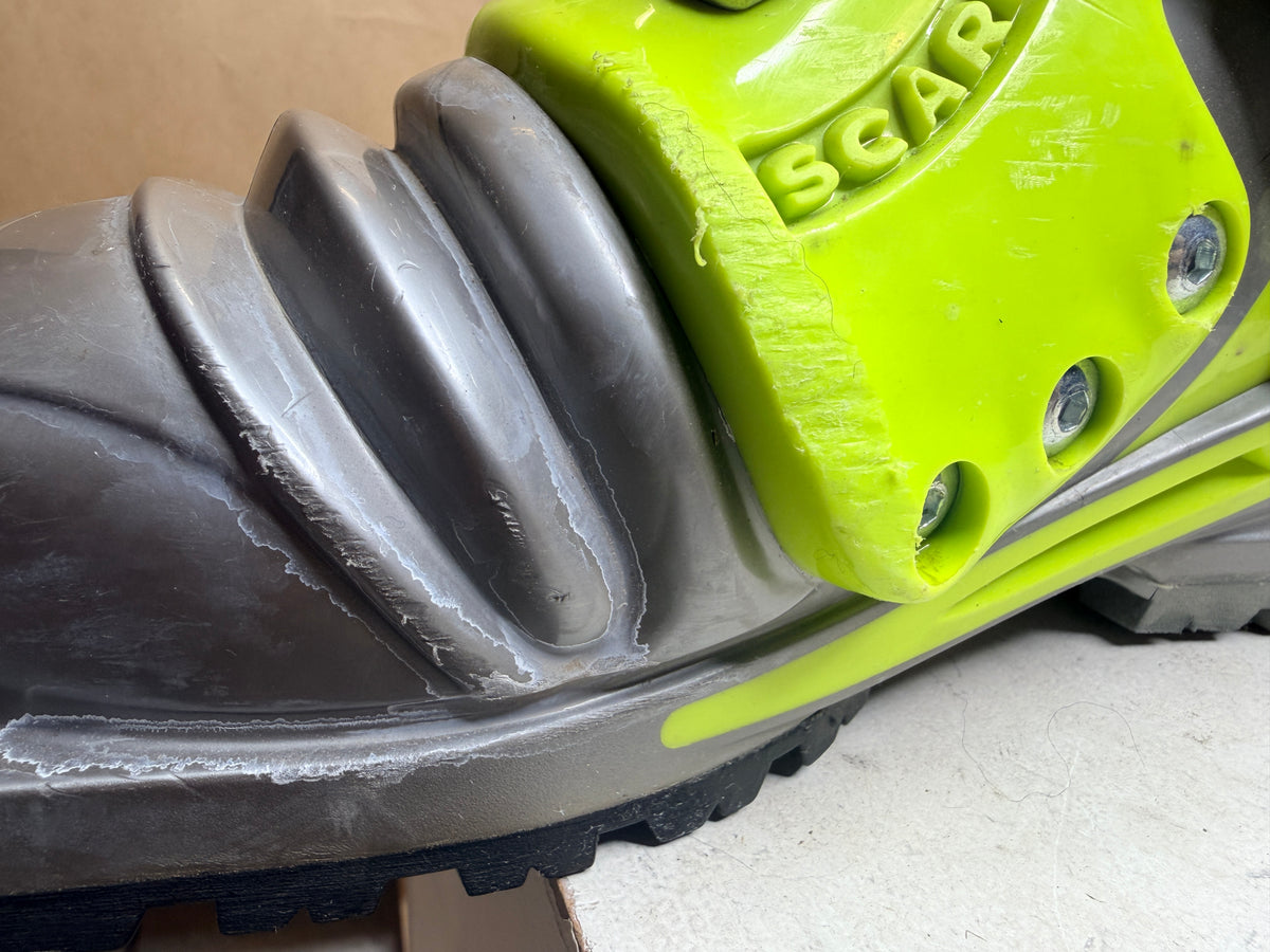 Close-up of cosmetic scuffs on the grey Scarpa T1 boot toe and bellows
